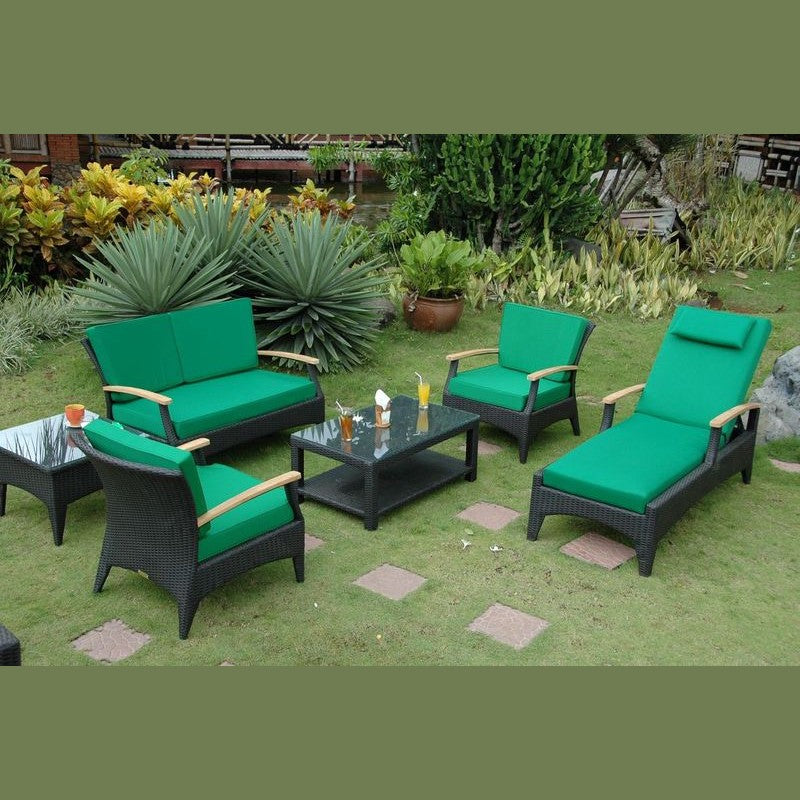 Green outdoor furniture set on a grassy area with plants in the background