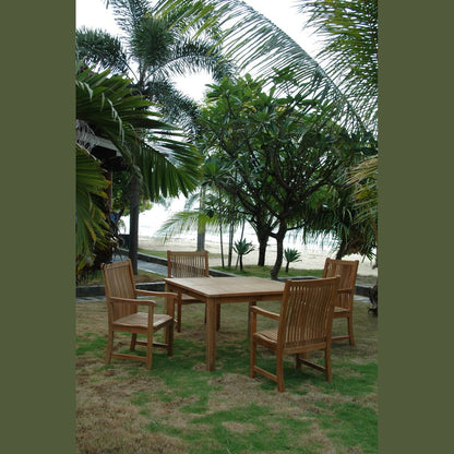 Wooden outdoor dining set with chairs on a grassy area near palm trees and a beach.