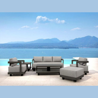 Outdoor furniture set with a scenic view of water and mountains.