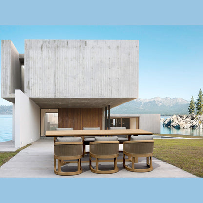 Modern house with a dining table and chairs by a waterfront