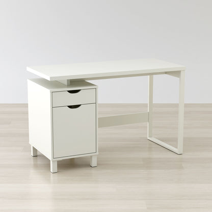 White desk with a drawer on a light wooden floor and white wall background