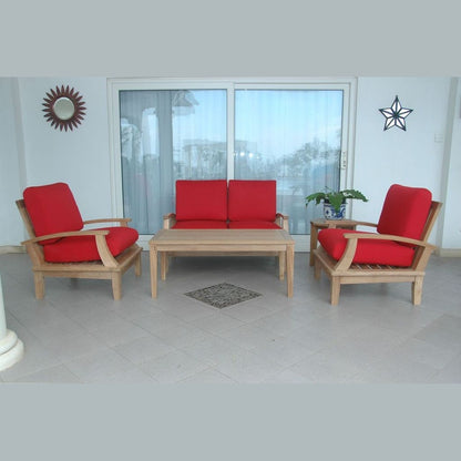 Outdoor furniture set with red cushions and a wooden table on a patio.