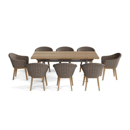 Wooden dining table with eight wicker chairs on a white background