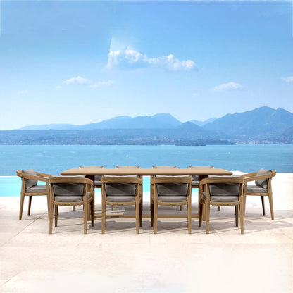 Outdoor dining set with table and chairs by a pool with a mountainous landscape in the background