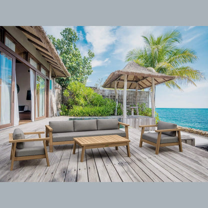 Outdoor seating area with wooden furniture on a deck overlooking the ocean.