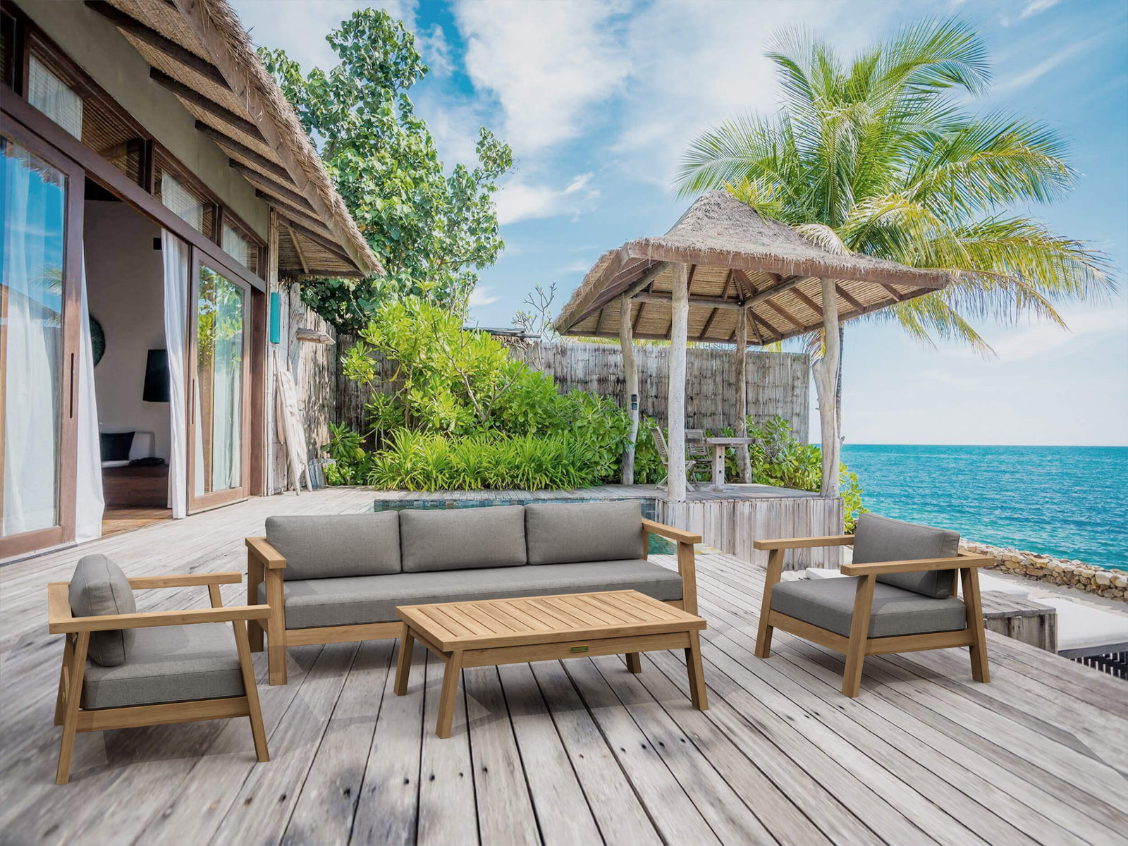Outdoor seating area with wooden furniture on a deck overlooking the ocean.