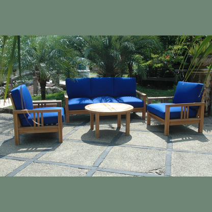 Outdoor furniture set with blue cushions on a stone patio