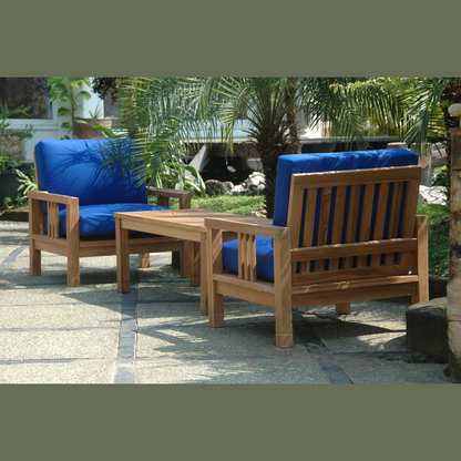 Wooden outdoor furniture set with blue cushions on a patio