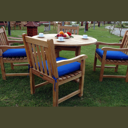 Outdoor setting with wooden chairs and table on grass