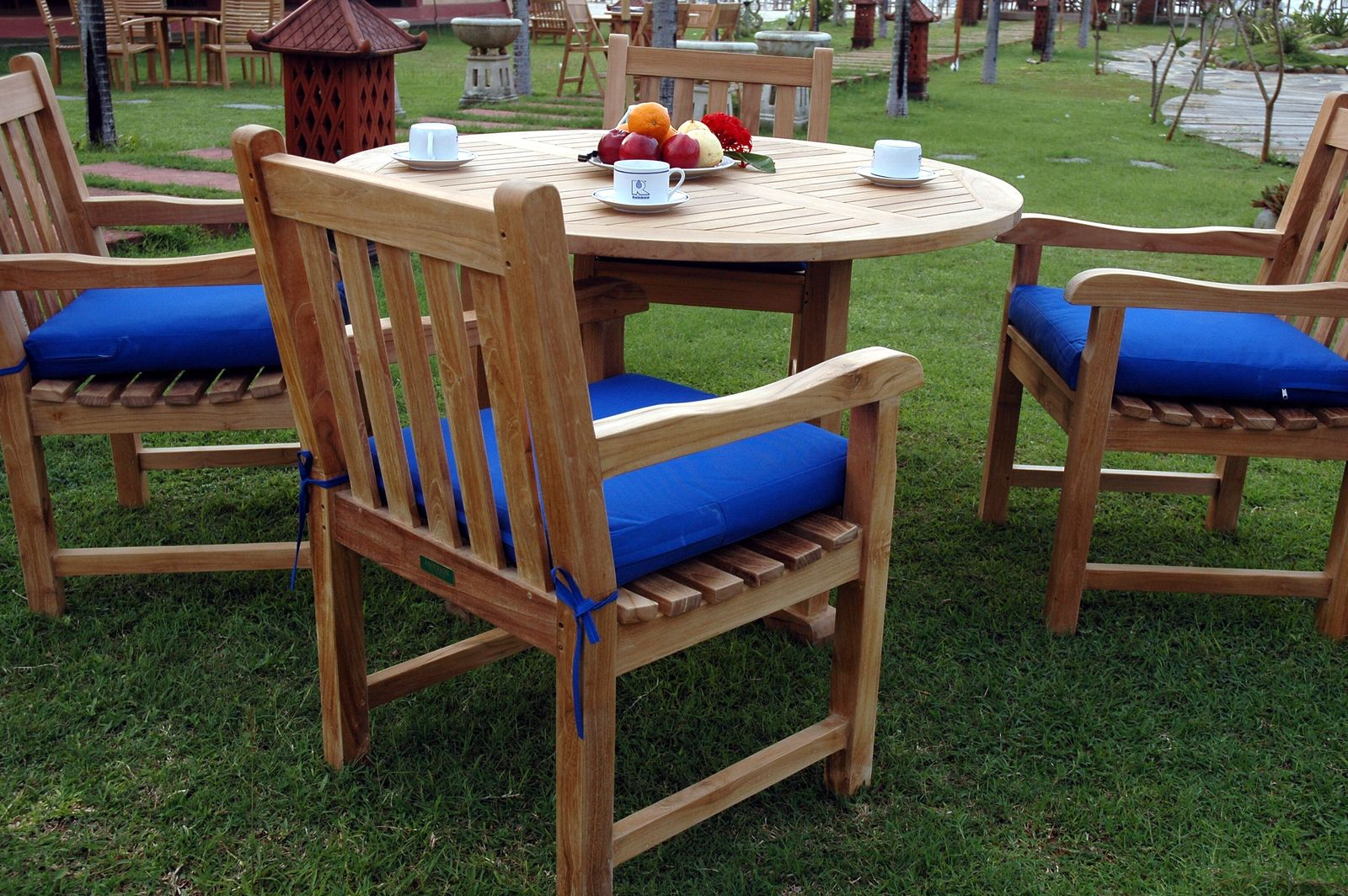 Outdoor setting with wooden chairs and table on grass