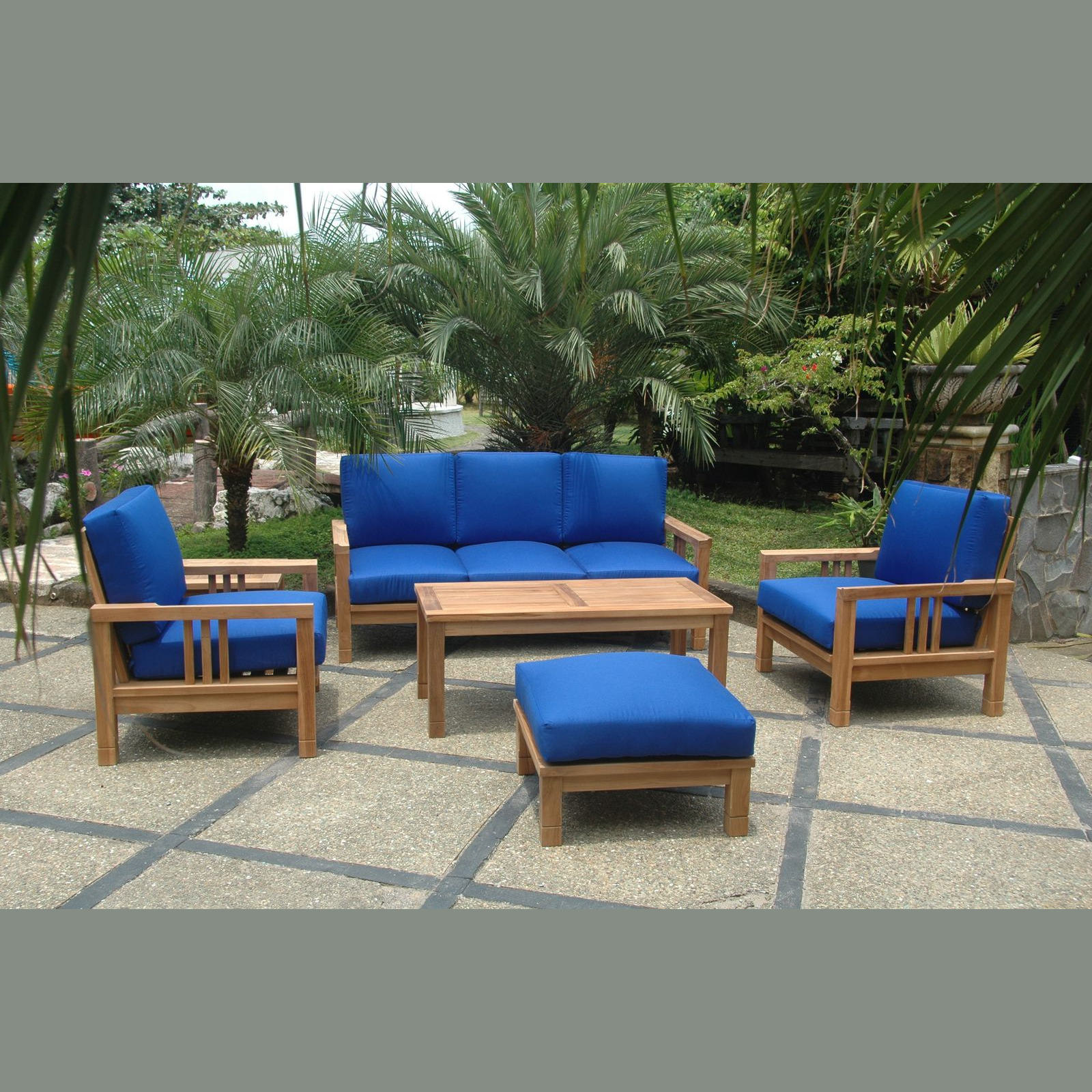 Outdoor furniture set with blue cushions on a patio