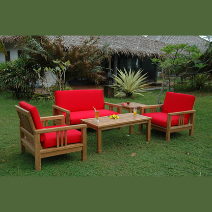 Outdoor furniture set with red cushions on a grassy area
