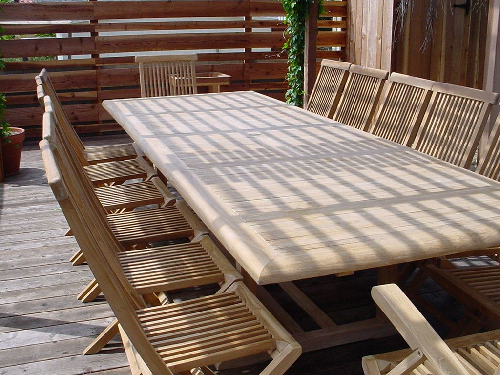 Wooden outdoor table with chairs on a wooden deck