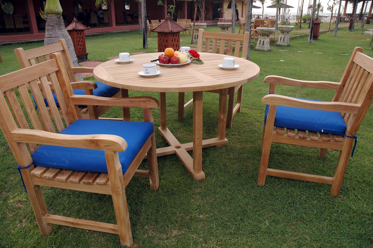 Wooden outdoor table with chairs on a grassy area