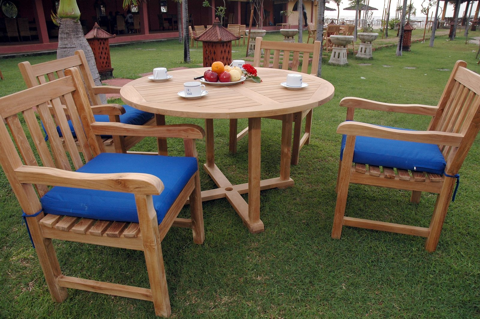 Wooden outdoor table with chairs on a grassy area