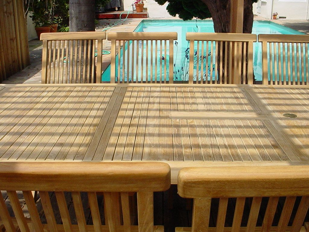 Wooden deck with a pool in the background