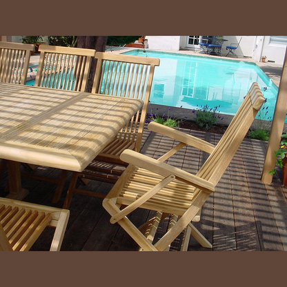 Wooden outdoor furniture set with table and chairs near a pool