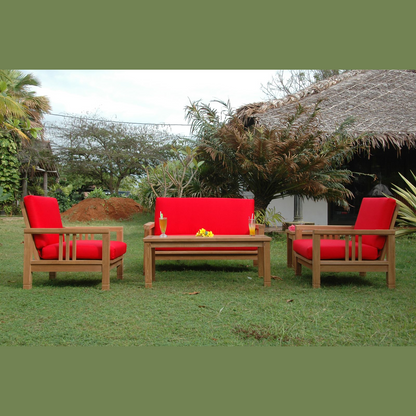Outdoor furniture set with red cushions on a grassy area
