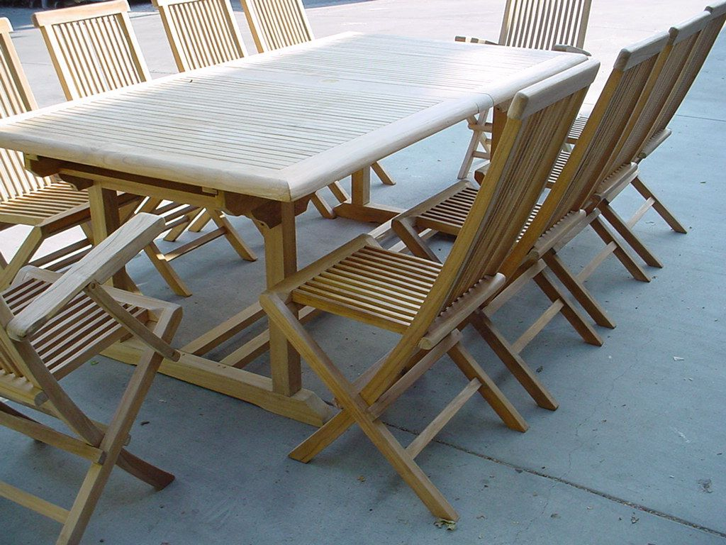 Wooden outdoor table and chairs on a concrete surface