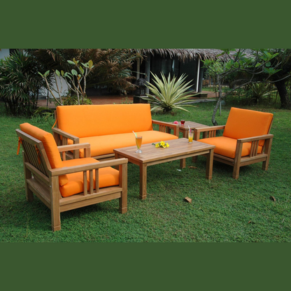 Outdoor furniture set with orange cushions on a grassy area