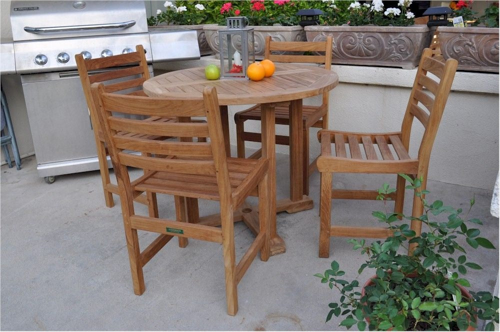 Wooden outdoor table with chairs on a patio