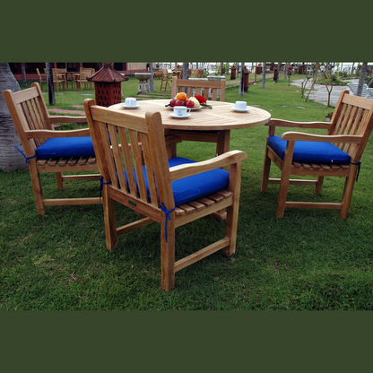Wooden outdoor dining set with blue cushions on chairs and a round table.