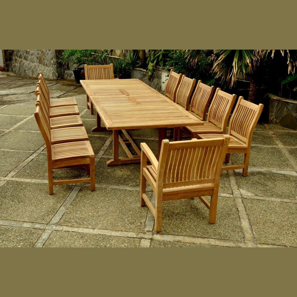 Wooden outdoor dining table with chairs on a stone patio