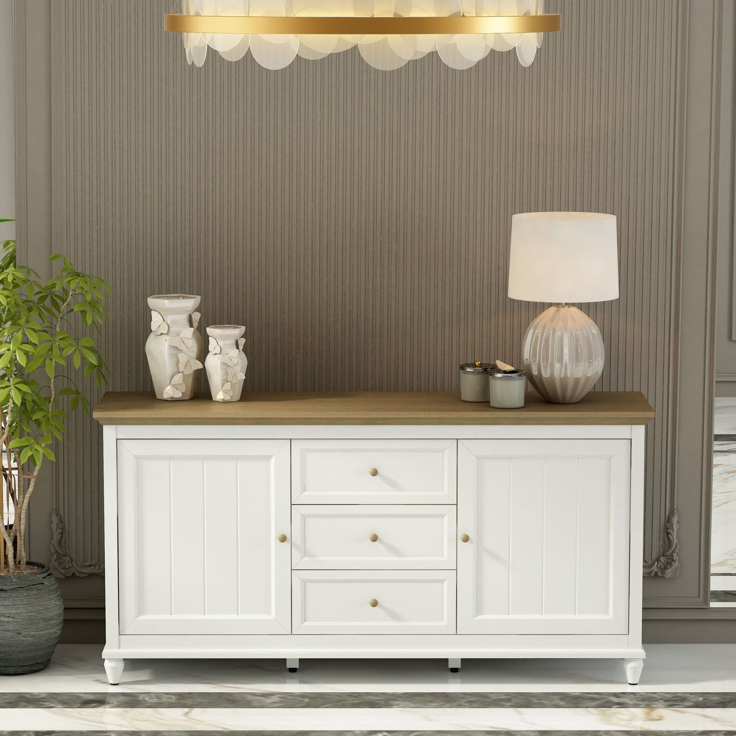 White sideboard with wooden top in a room with striped wallpaper and a chandelier.