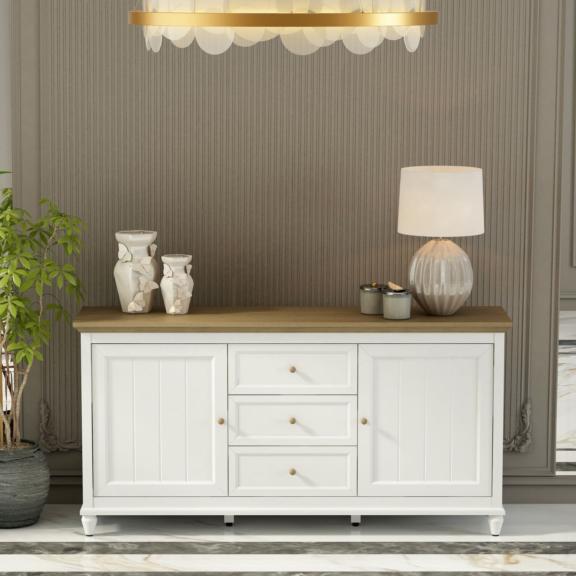 White sideboard with wooden top in a room with striped wallpaper and a chandelier.