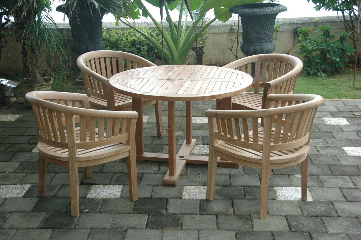 Wooden outdoor dining set with round table and four chairs on a stone patio.