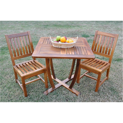 Wooden outdoor table with two chairs on a grassy area