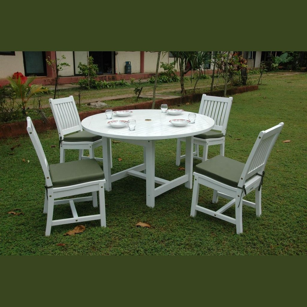 Round white table with four matching chairs on a grassy area