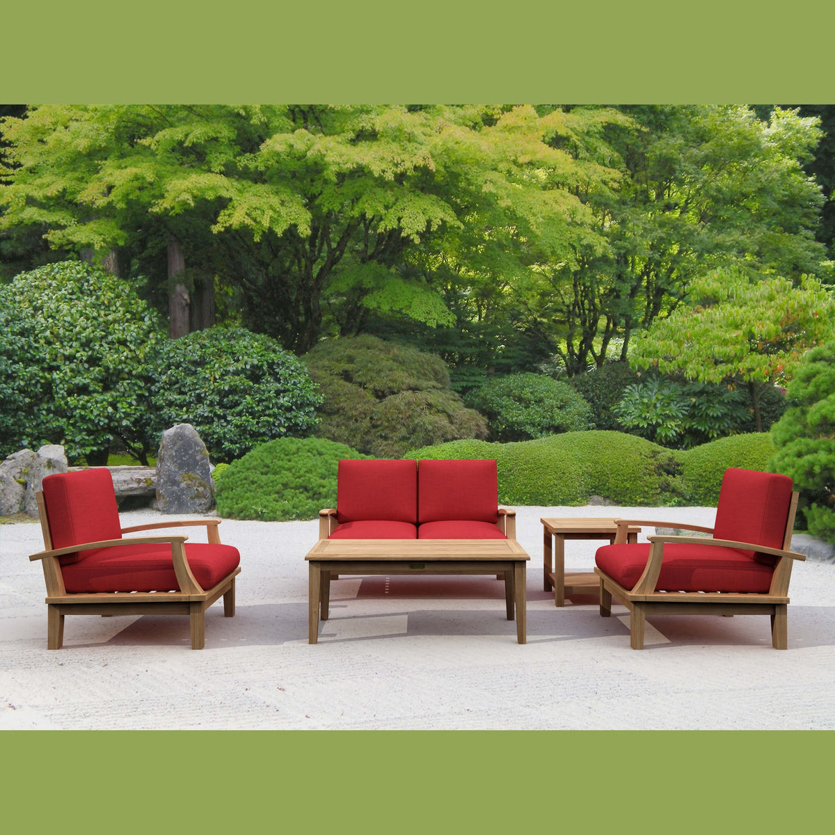 Outdoor furniture set with red cushions in a garden setting