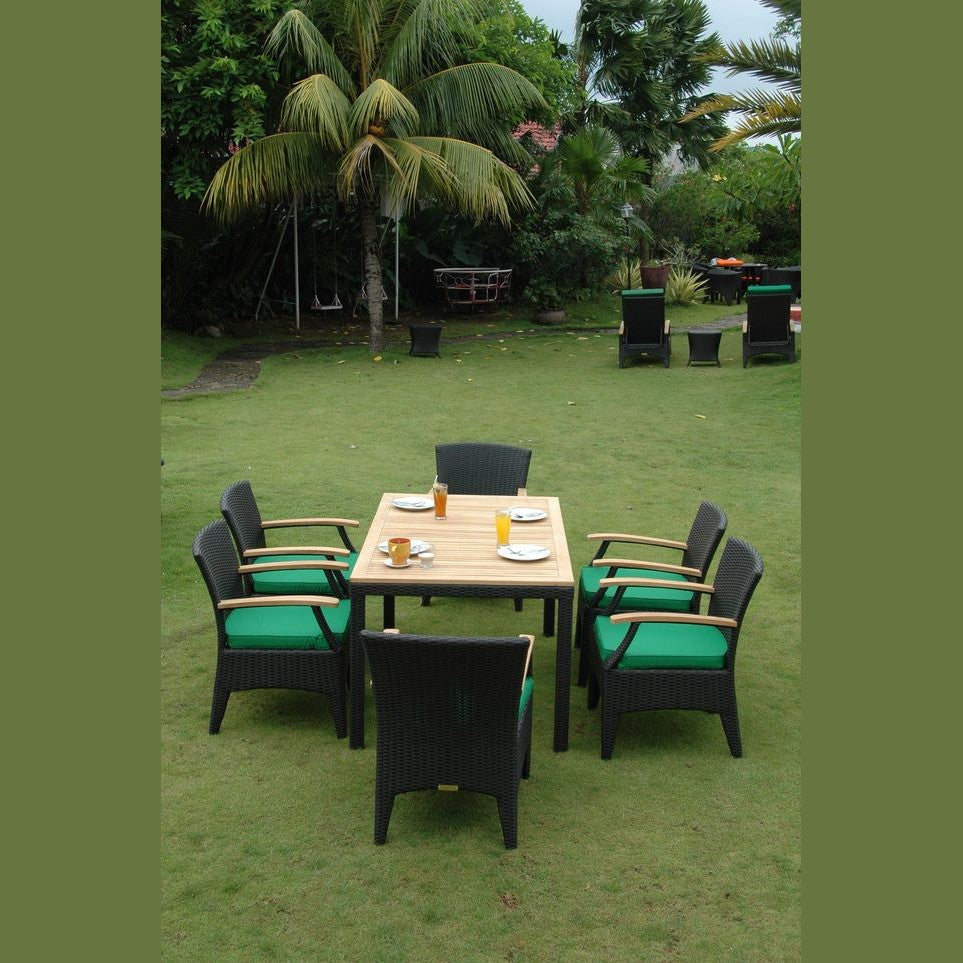Outdoor patio set with table and chairs on a grassy area with palm trees in the background