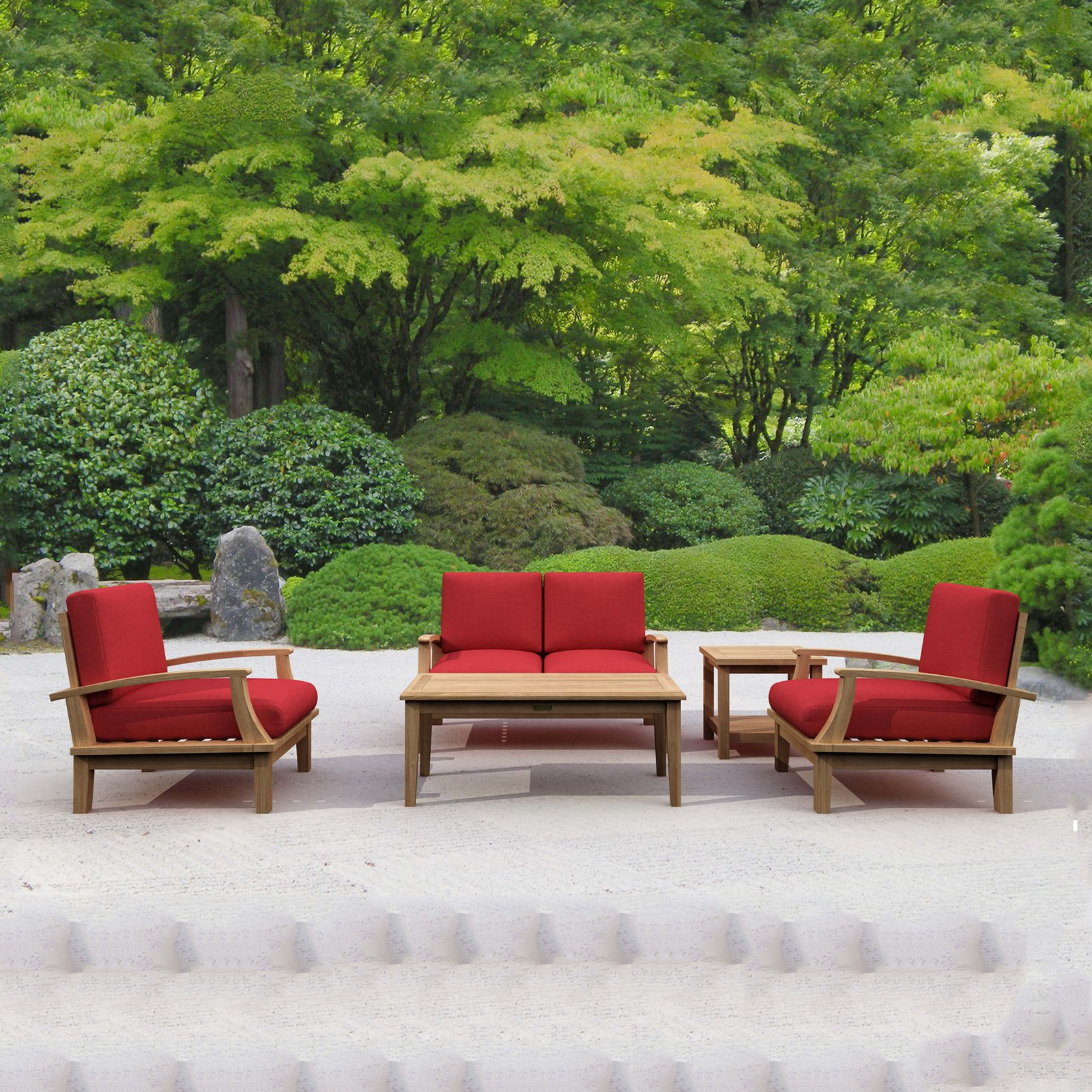 Outdoor furniture set with red cushions and wooden frames in a garden setting.