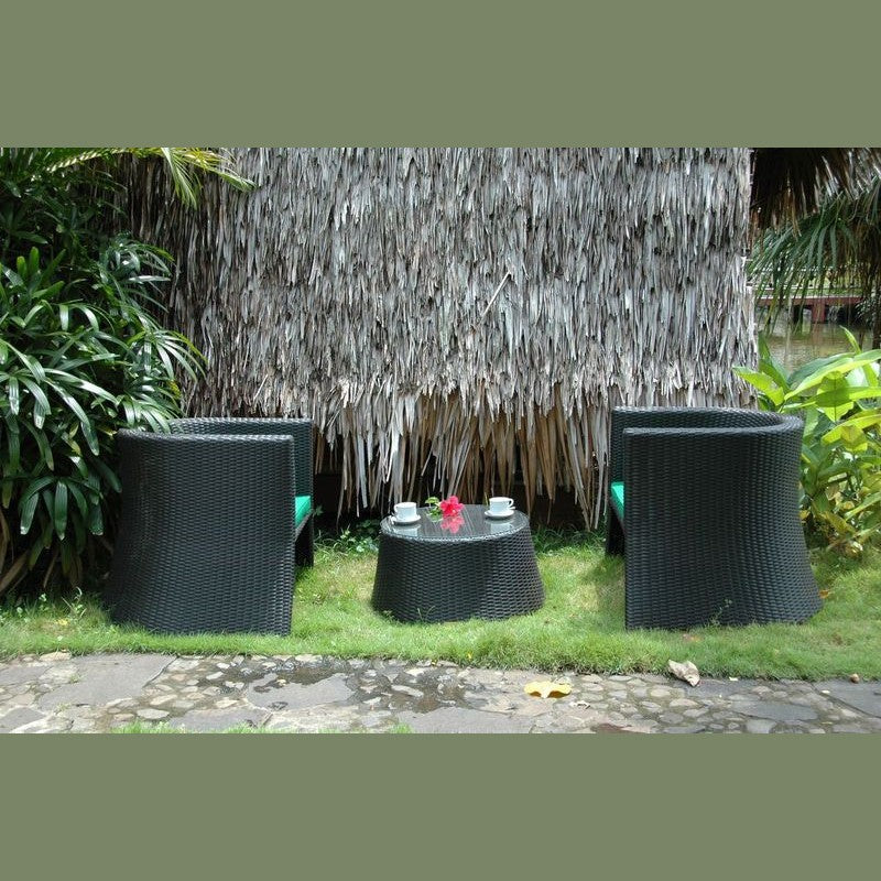 Black outdoor furniture set with a small round table and chairs against a thatched wall.