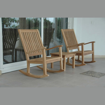 Two wooden rocking chairs on a patio with glass doors in the background.