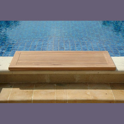 Wooden deck board on a stone ledge by a pool
