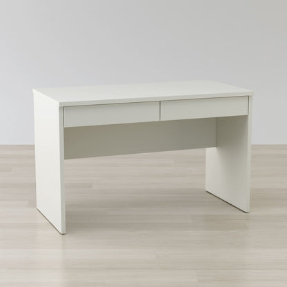 White office desk on a light wooden floor with a plain white wall background