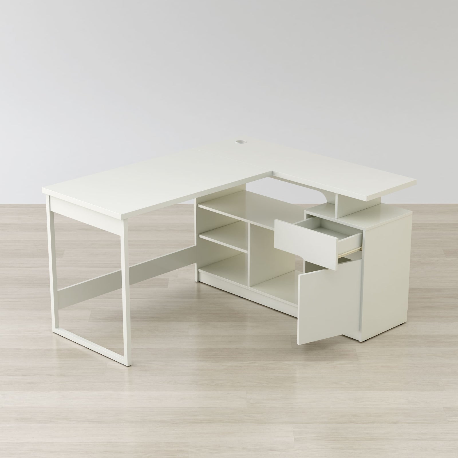 White L-shaped desk with a drawer on a light wooden floor.