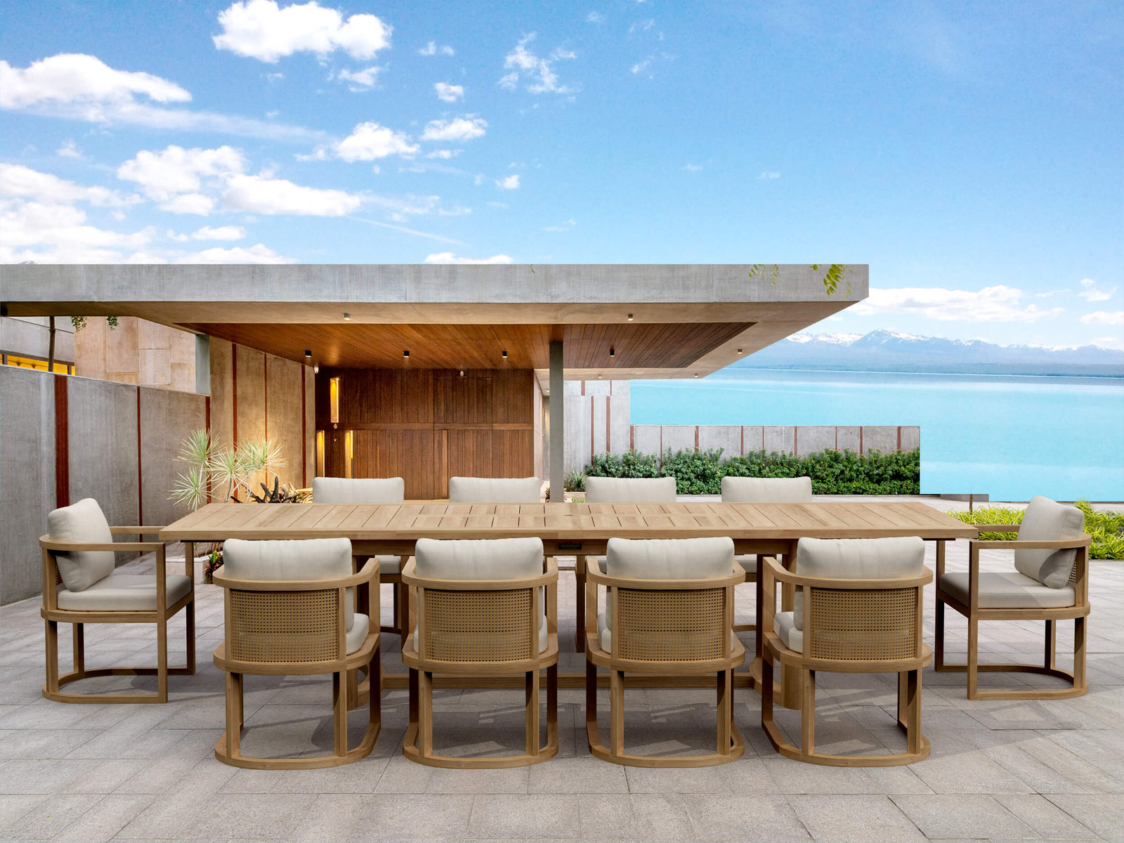 Outdoor dining set with wooden table and chairs on a deck with ocean view