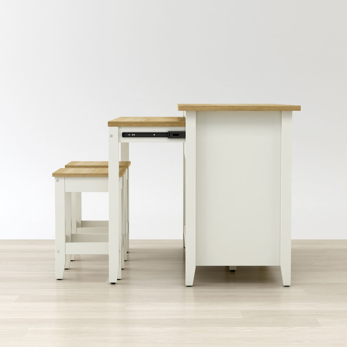 Set of white tables with wooden tops on a light wood floor.