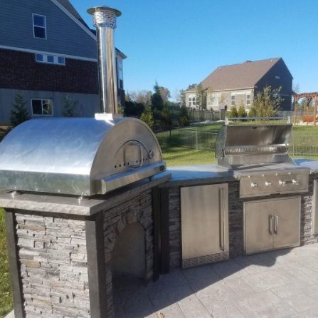 Outdoor Stone Kitchen With Firebrick Pizza Oven and Large Rotisserie bbq